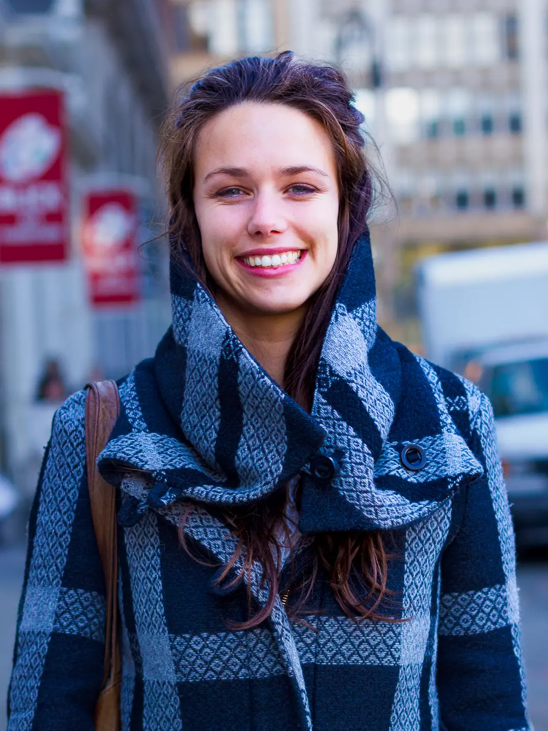 Human Rights Lawyer, Sian Davin in a blue and gray coat on Bond Street.